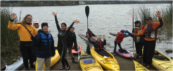 Group posing with kayaks